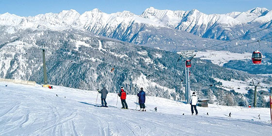 Skiers on Speiereck Mountain in Oberlungau, Austria