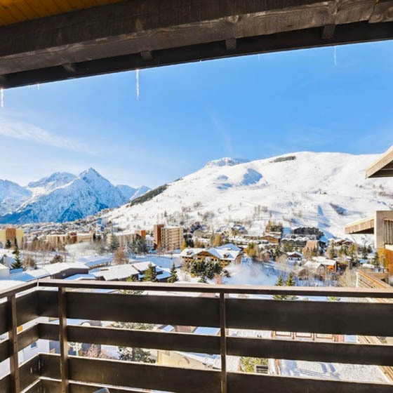 View over the snowy mountains from the balcony at Hotel Turan