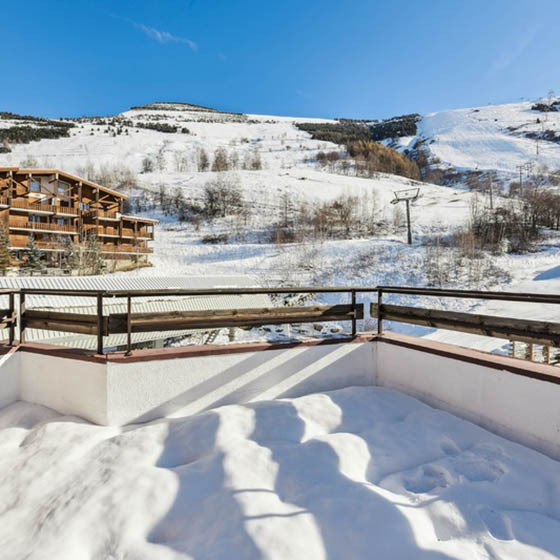 View over the snowy mountains from the balcony at Hotel Turan