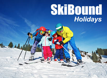 Family posing with ski gear on the slopes